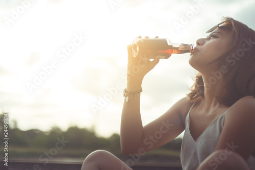 A beautiful girl drinking a whisky between travel alone for her vacation time.