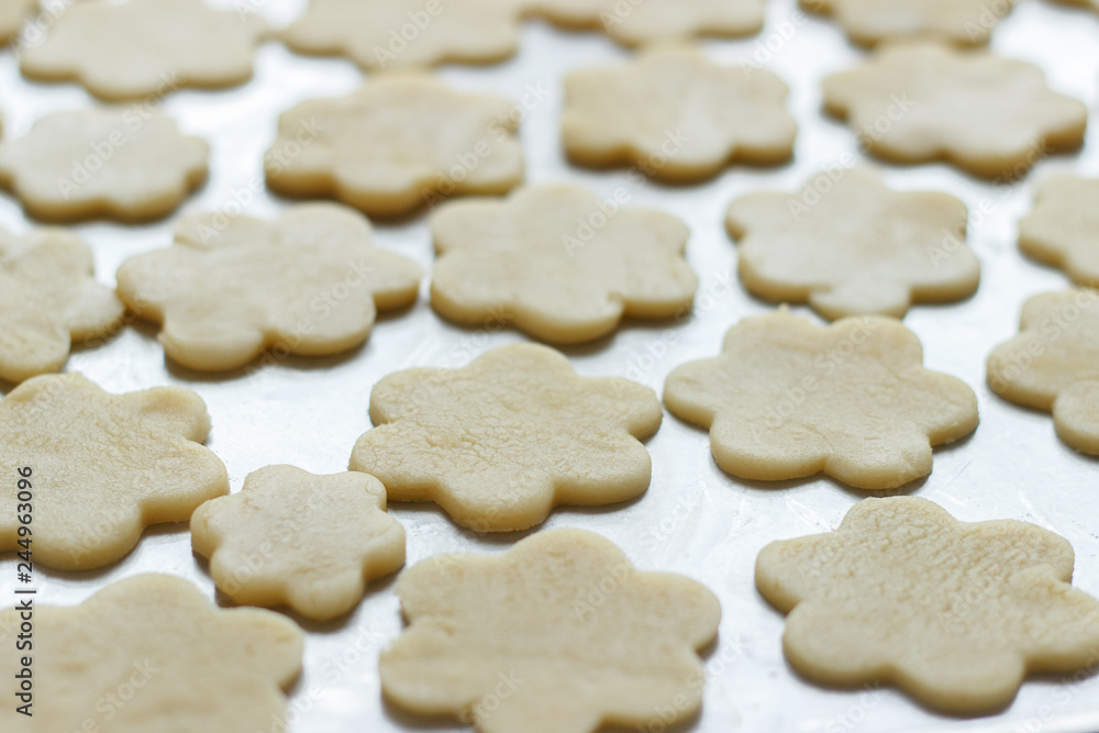 Flower shaped cookies on a metal tray Flower shaped cookies on a metal tray