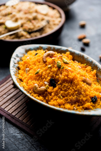 Badaam kesar shira / Sheera or almond saffron halwa, popular Indian dessert served in a bowl. selective focus
