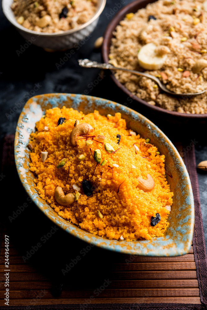 Badaam kesar shira / Sheera or almond saffron halwa, popular Indian dessert served in a bowl. selective focus