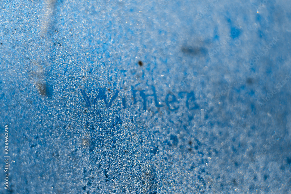 Obraz premium The inscription: winter on a frozen winter window. Background