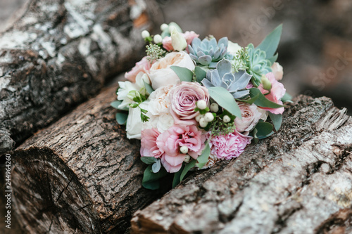 wedding bouquet lies on the logs. soft focus