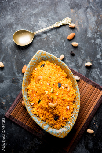 Badaam kesar shira / Sheera or almond saffron halwa, popular Indian dessert served in a bowl. selective focus