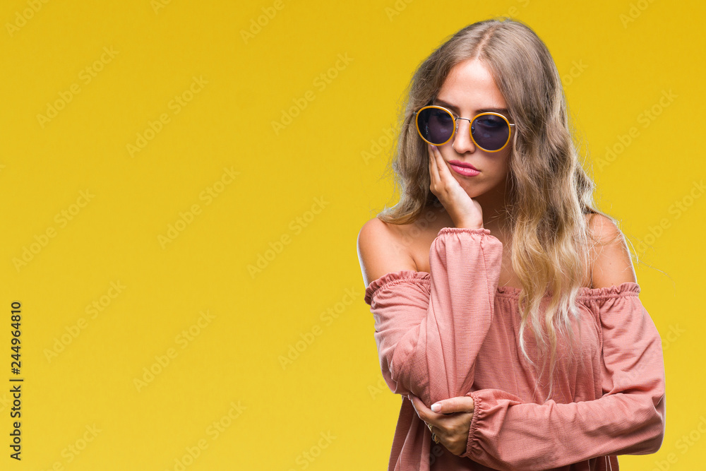Fototapeta premium Beautiful young blonde woman wearing retro sunglasses over isolated background thinking looking tired and bored with depression problems with crossed arms.