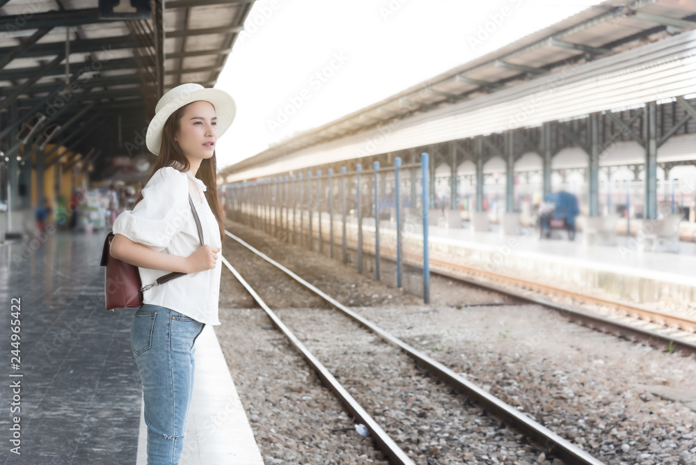 Asian traveler woman wait train at railway station.Travel holiday,relaxation concept. Asian traveler woman wait train at railway station.Travel holiday,relaxation concept.