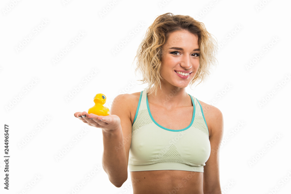 Portrait of beautiful young fit girl holding bath duck Portrait of beautiful young fit girl holding bath duck