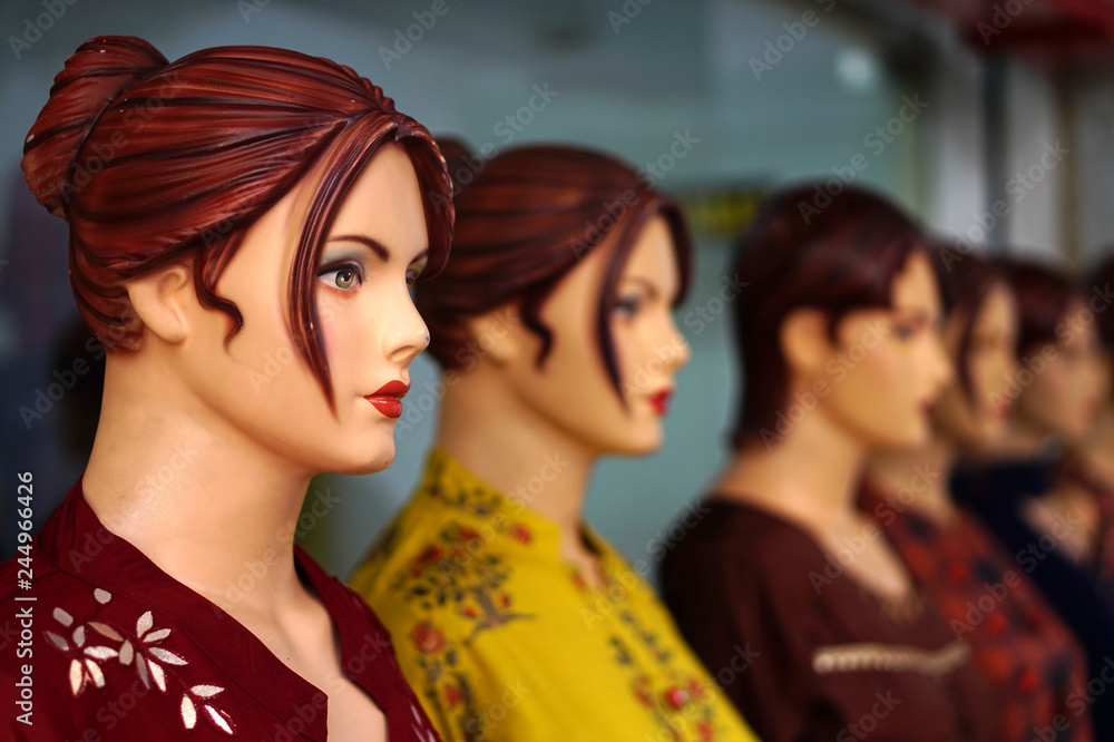 View of Mannequins, in latest  Indian woman fashion wear, kept as display in front of a retail store  