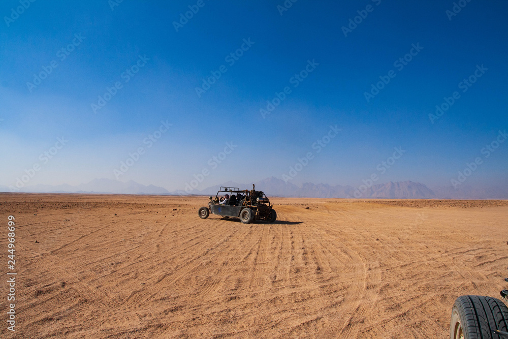 Buggy car and martian landscape of egyptian desert Buggy car and martian landscape of egyptian desert