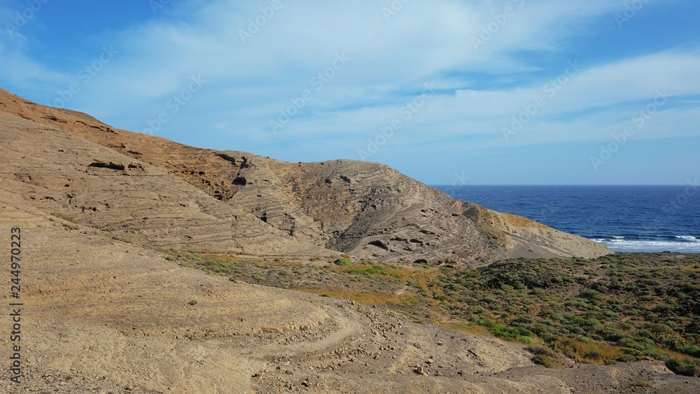Mountain Pelada, locally known as Montana Pelada, an arid volcanic cone formed of fossilized sand dunes, situated at one end of El Medano surf resort in south of Tenerife, Canary Islands, Spain