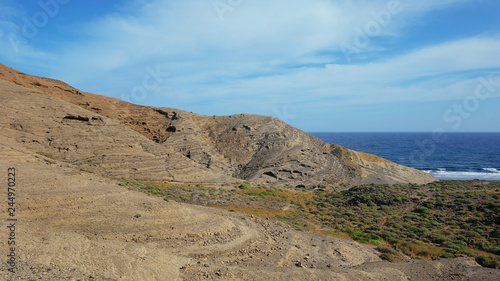 Mountain Pelada, locally known as Montana Pelada, an arid volcanic cone formed of fossilized sand dunes, situated at one end of El Medano surf resort in south of Tenerife, Canary Islands, Spain