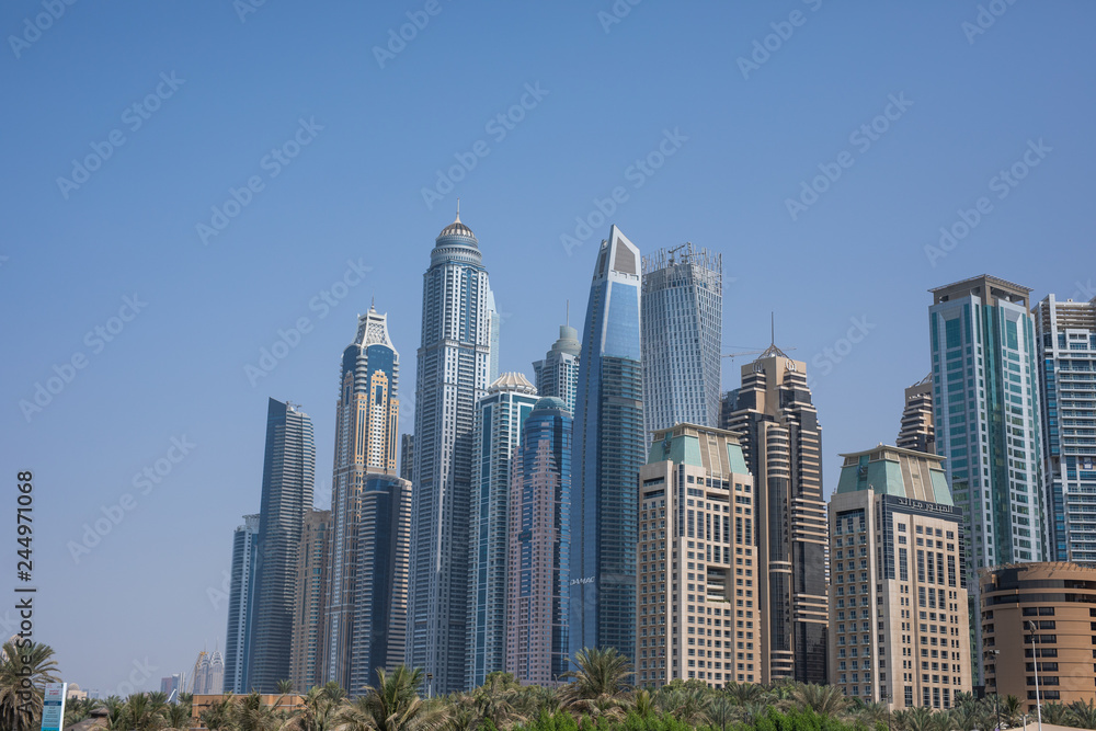 Skyscapers next to the beach in Dubai Jumeirah beach. Landscape view.