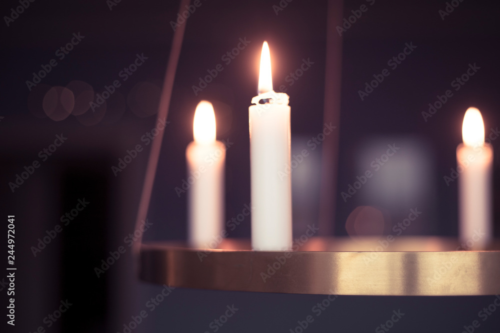 Candles glowing on advent chandelier. Candles glowing on advent chandelier.