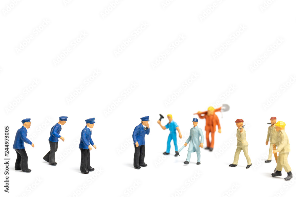 Miniature people : Police and an angry mob on white background Miniature people : Police and an angry mob on white background