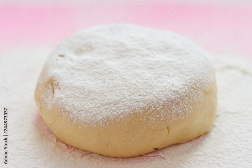 Dough, cookie cutters, flowers on a pink silicone board sprinkled with flour Dough, cookie cutters, flowers on a pink silicone board sprinkled with flour