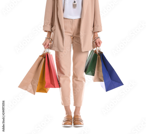 Young woman with shopping bags on white background, closeup