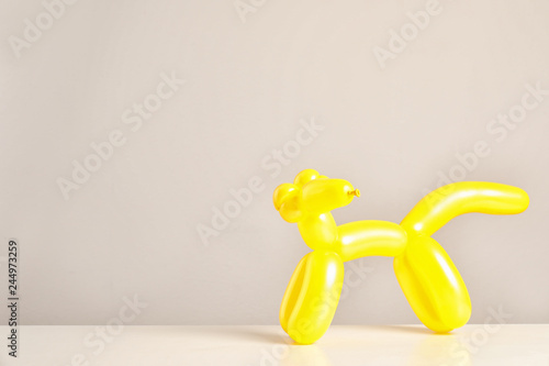Fototapeta Naklejka Na Ścianę i Meble -  Animal figure made of modelling balloon on table against color background. Space for text