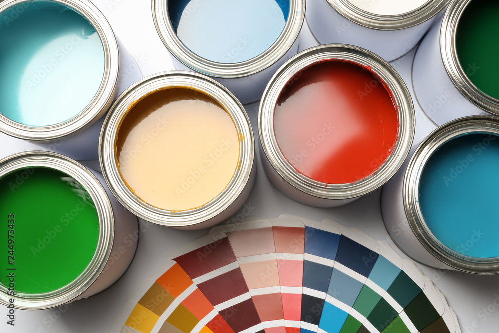 Fototapeta premium Paint cans and color palette on white background, top view
