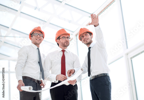 architects show the client the layout of the new building