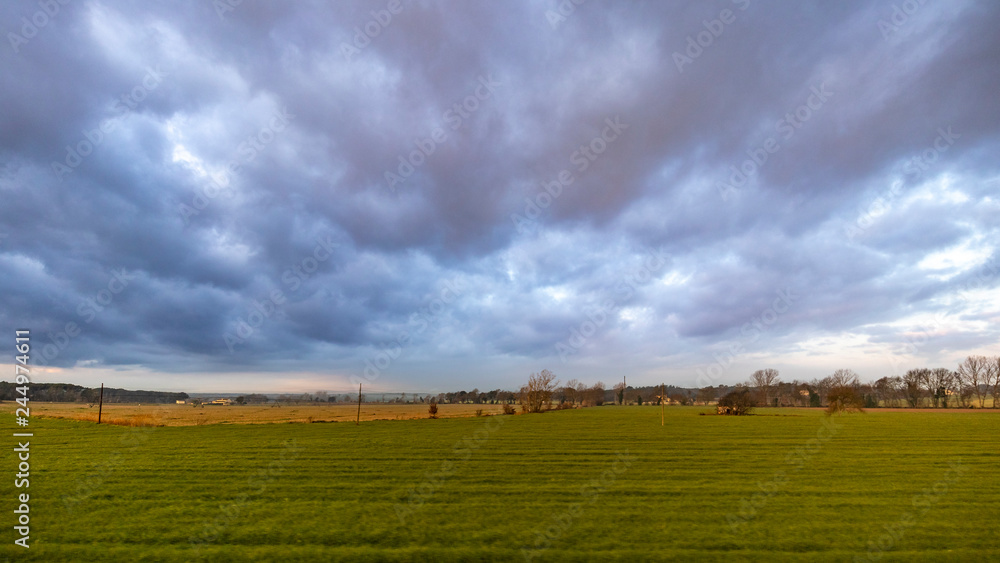 Dark cloudscape landscape on a green cultivated field