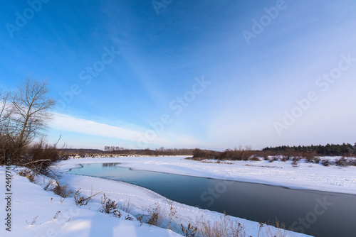 winter landscape. the river didn't freeze completely. panorama of sky and river