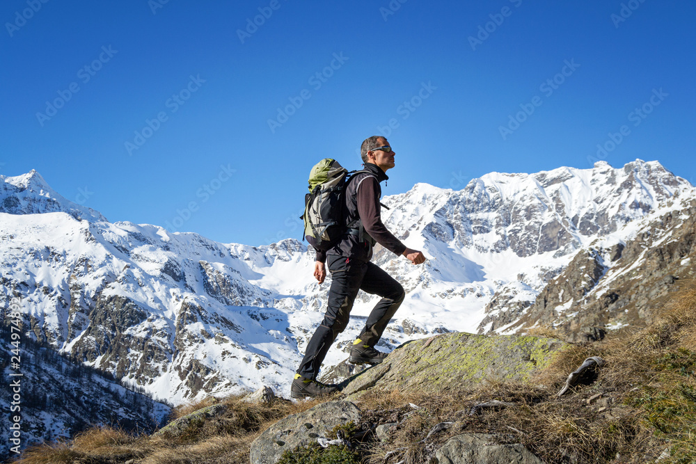Man trekking in the Alps. Grand Paradiso National Park. Italy Man trekking in the Alps. Grand Paradiso National Park. Italy