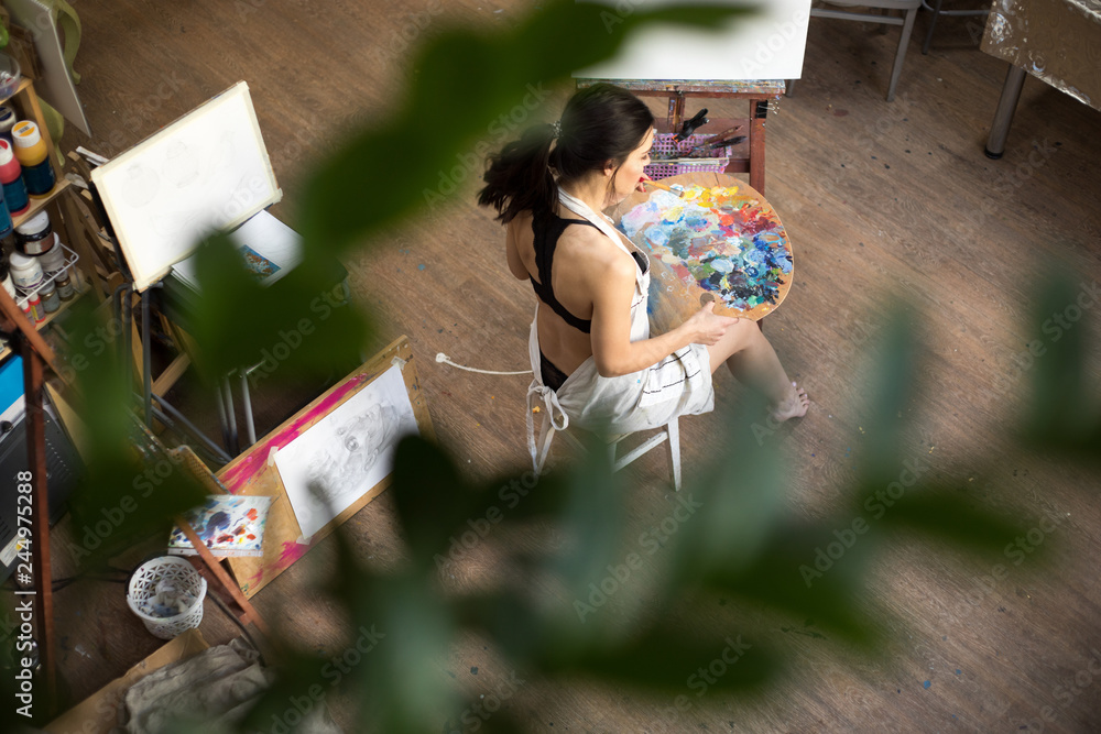 Fototapeta premium Professional Woman artist painting picture in art studio.