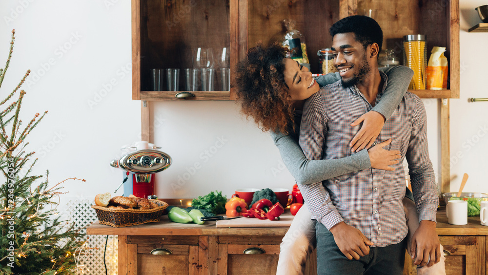 Loving african-american couple enjoying time together in kitchen