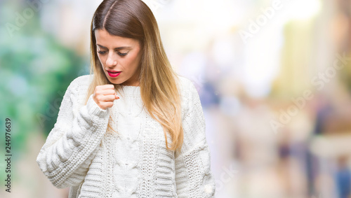 Young beautiful woman casual white sweater over isolated background feeling unwell and coughing as symptom for cold or bronchitis. Healthcare concept. © Krakenimages.com