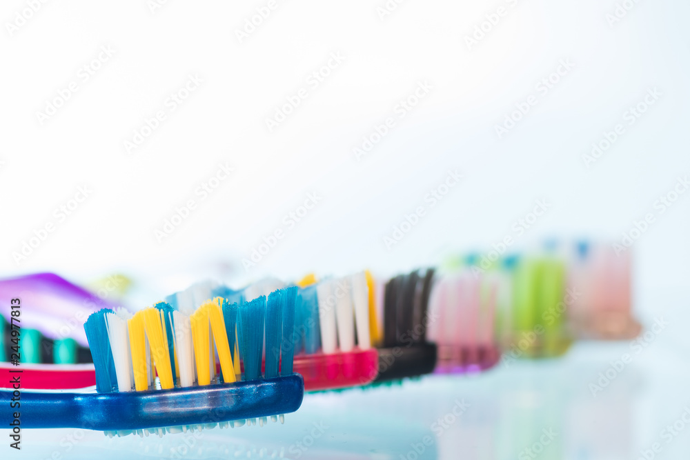 Several toothbrushes one by one next to the toothpaste Several toothbrushes one by one next to the toothpaste