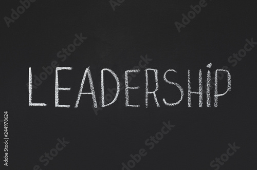 Word Leadership written with white chalk on blackboard