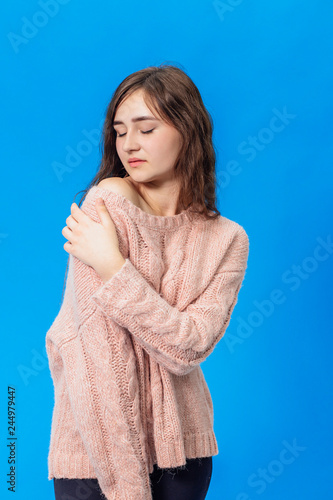 Young beautiful girl isolated on blue background © Andrii