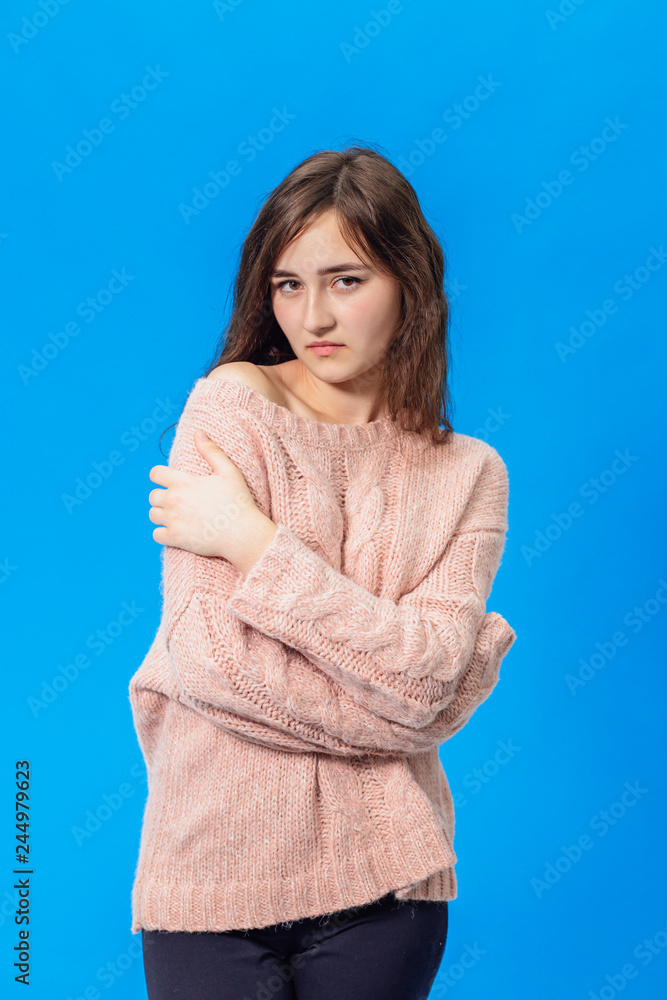 Young beautiful girl isolated on blue background Young beautiful girl isolated on blue background