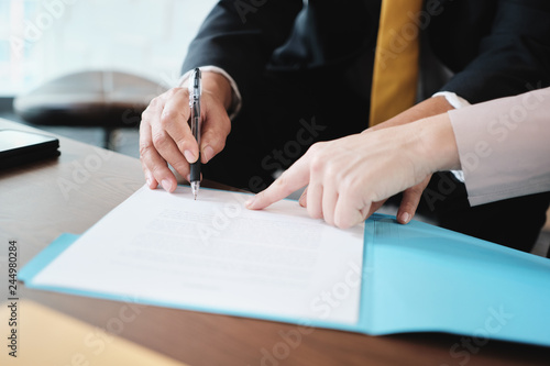 Asian Manager Signing Agreement For Health Insurance With Business Woman
