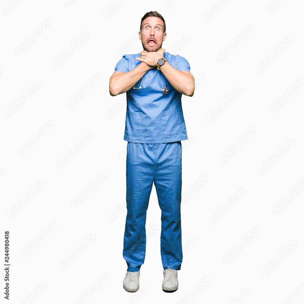 Handsome doctor man wearing medical uniform over isolated background shouting and suffocate because painful strangle. Health problem. Asphyxiate and suicide concept. Handsome doctor man wearing medical uniform over isolated background shouting and suffocate because painful strangle. Health problem. Asphyxiate and suicide concept.