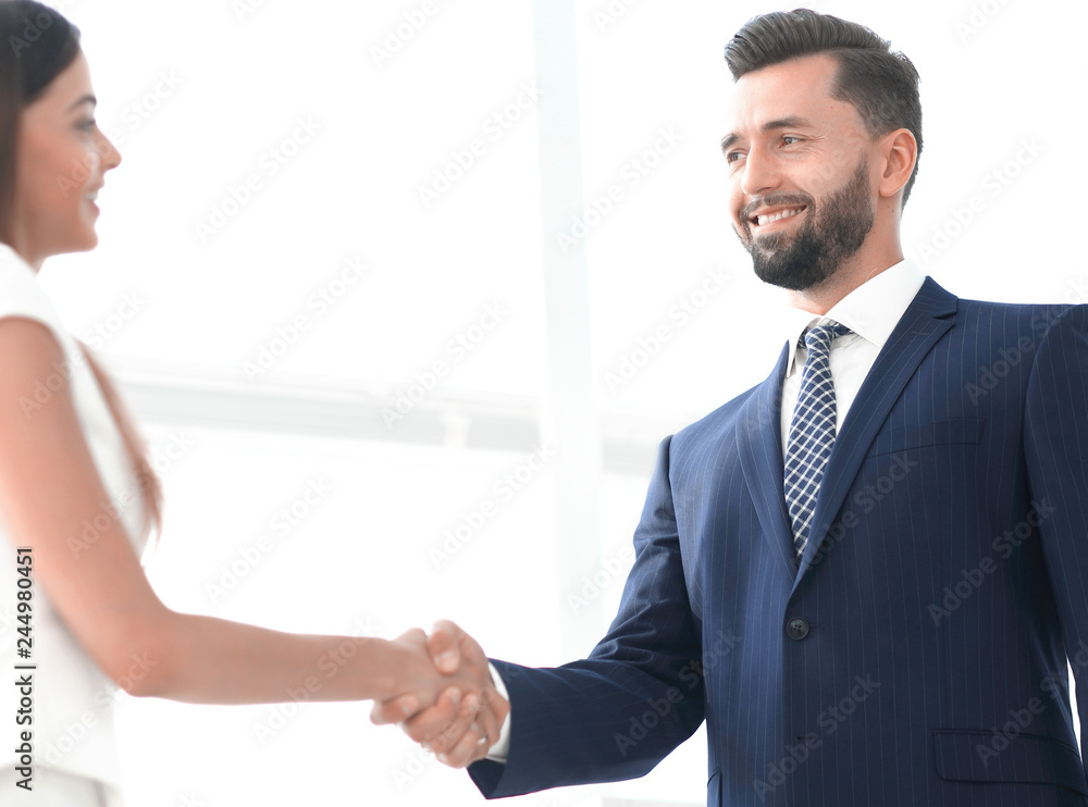 Image of business partners handshaking in office Image of business partners handshaking in office