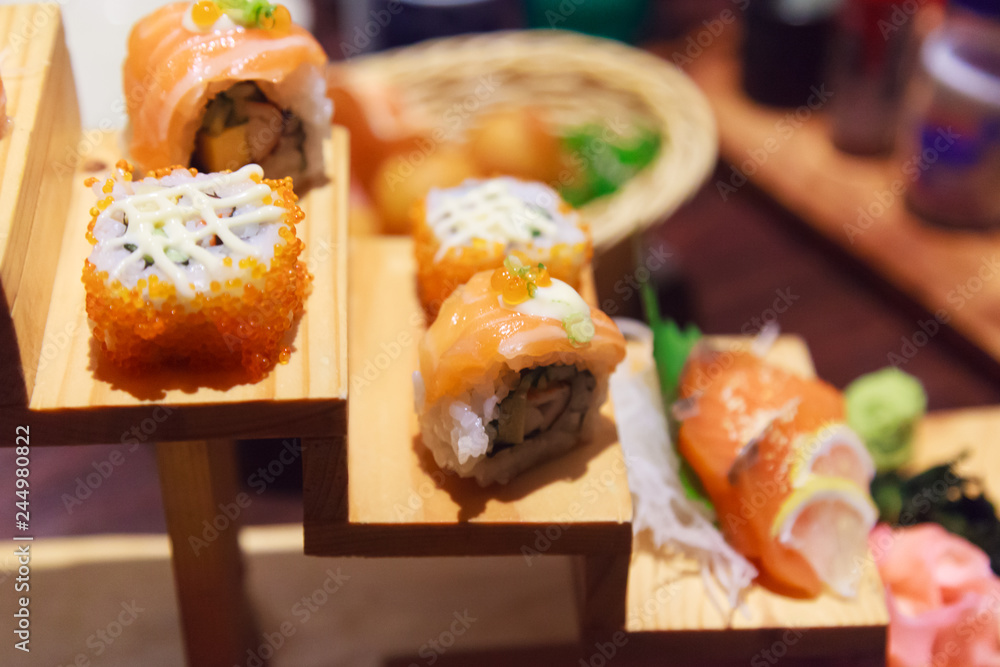 Japanese Fresh Fish Food Dish Menu, Salmon Sushi and Sashimi Assortment decorating on wooden steps in traditional Japanese Restaurant. Healthy Food rich with fish nutrition and Delicious meal concept Japanese Fresh Fish Food Dish Menu, Salmon Sushi and Sashimi Assortment decorating on wooden steps in traditional Japanese Restaurant. Healthy Food rich with fish nutrition and Delicious meal concept