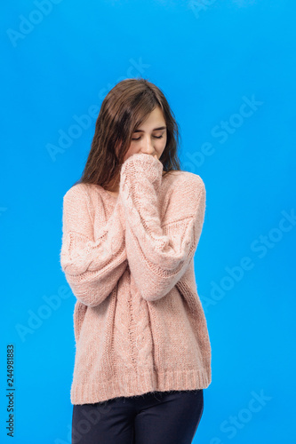 Young beautiful girl isolated on blue background © Andrii