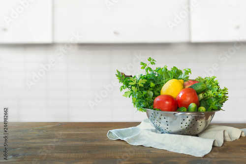 Blurred background. Modern kitchen with fresh vegetables on wooden tabletop, space for display products.