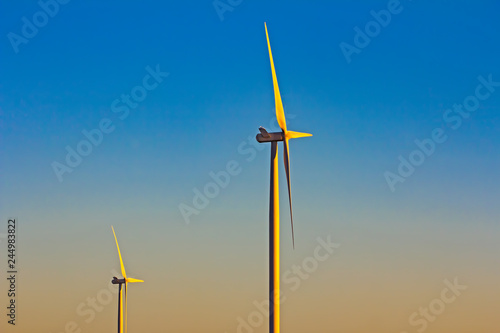 Two wind turbines in early morning photo