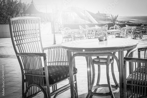 Beautifully stylish table chairs for eating people at sea background