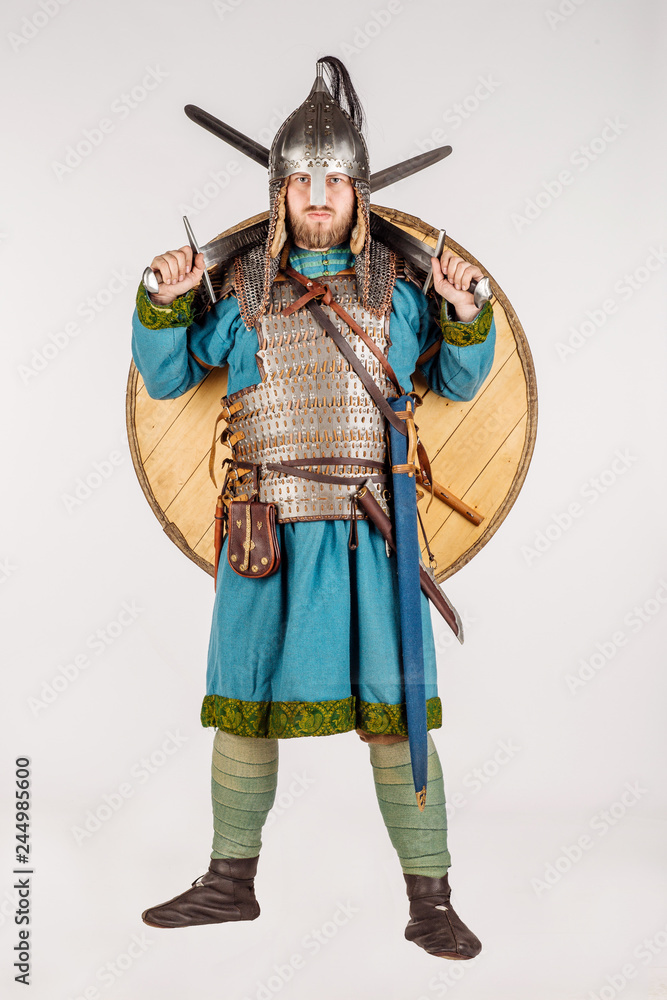 medieval soldier with helmet, hauberks, sword and shields isolated on white background. historical concept.