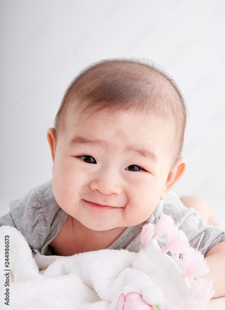 Closeup Asian baby lying on the clean ground Closeup Asian baby lying on the clean ground