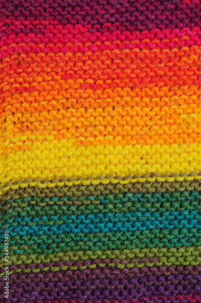 Handmade rainbow colored seamless knitted patterns texture with horizontal rows