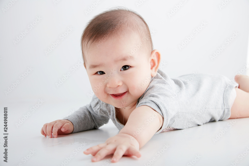 Closeup Asian baby lying on the clean ground Closeup Asian baby lying on the clean ground