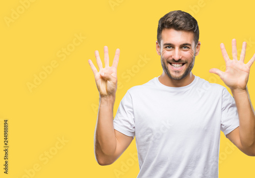 Young handsome man over isolated background showing and pointing up with fingers number nine while smiling confident and happy.