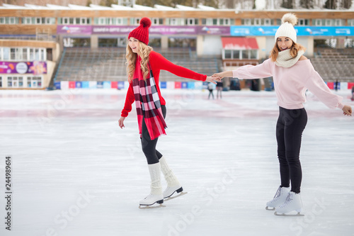 women ice skating outdoor at ice rink © petunyia
