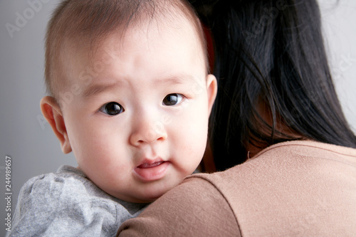Asian young mother holding a baby in her arms 