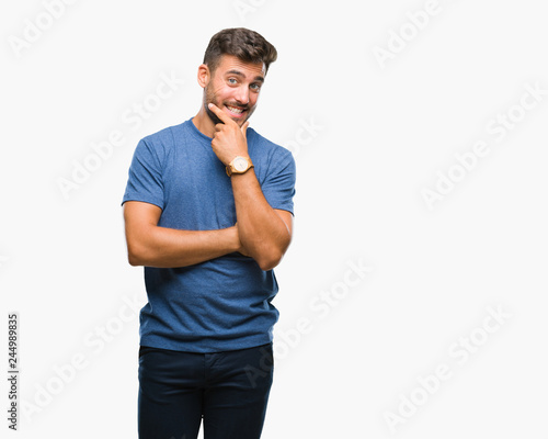Young handsome man over isolated background looking confident at the camera with smile with crossed arms and hand raised on chin. Thinking positive.