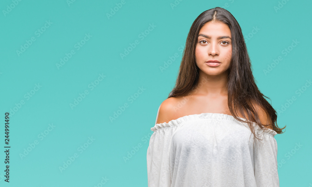Young beautiful arab woman over isolated background with serious expression on face. Simple and natural looking at the camera. Young beautiful arab woman over isolated background with serious expression on face. Simple and natural looking at the camera.
