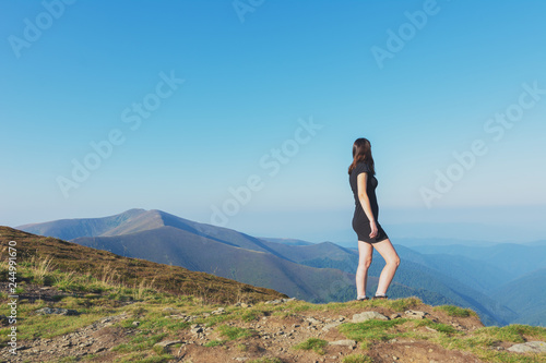 Girls on a mountain ridge rest with tents.